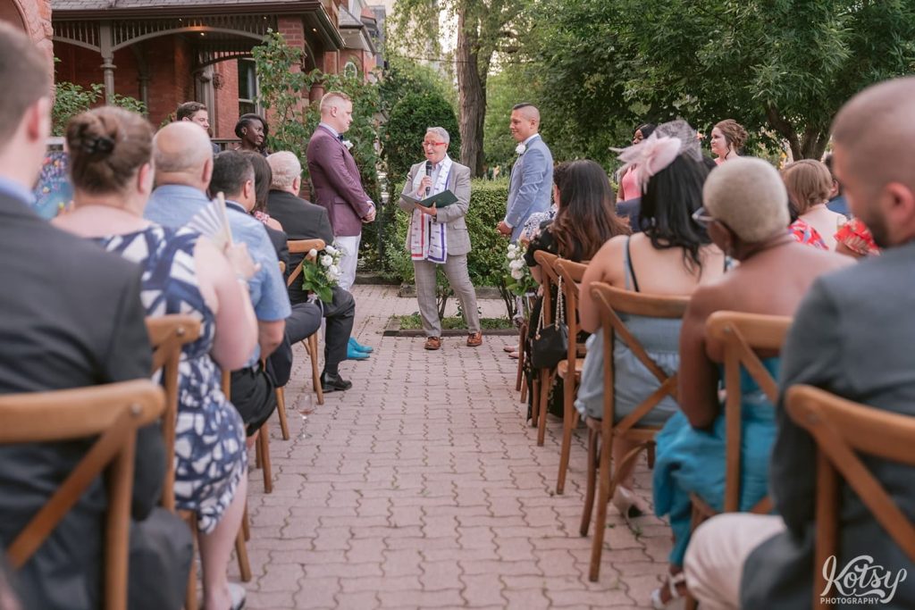 A shot down the aisle at an outdoor wedding ceremony at Berkeley Bicycle Club in Toronto, Ontario