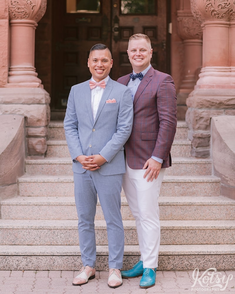 Two grooms pose next to each other before their wedding at Berkeley Bicycle Club in Toronto