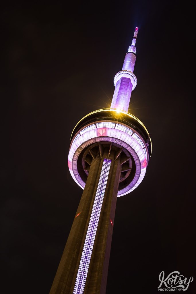 A shot looking up at the CN Tower with hearts around the lower pod during the Covid-19 pandemic in Toronto