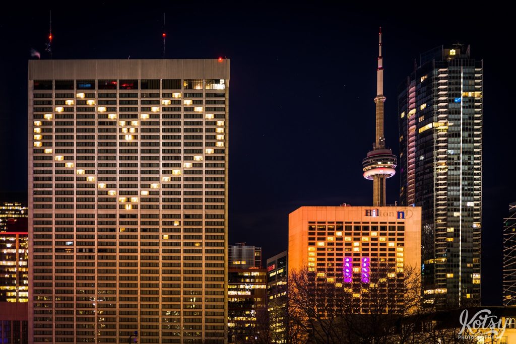 A heart is seen from hotel room lights on at Sheraton Centre and Hilton Hotels in Toronto during the Covid-19 pandemic