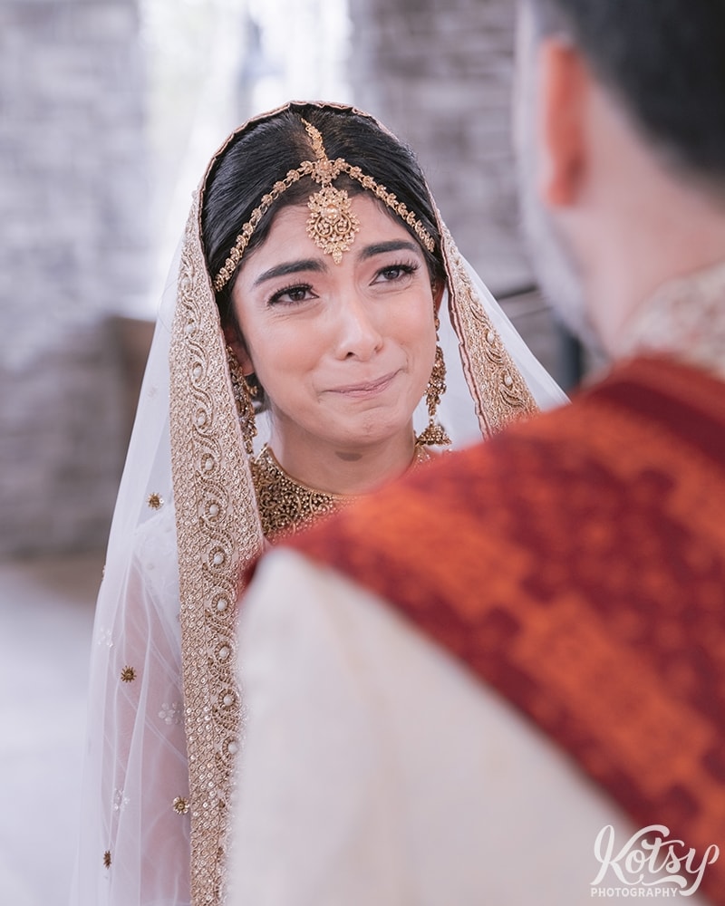 A bride fights back tears during her wedding ceremony at Guild Inn Estates