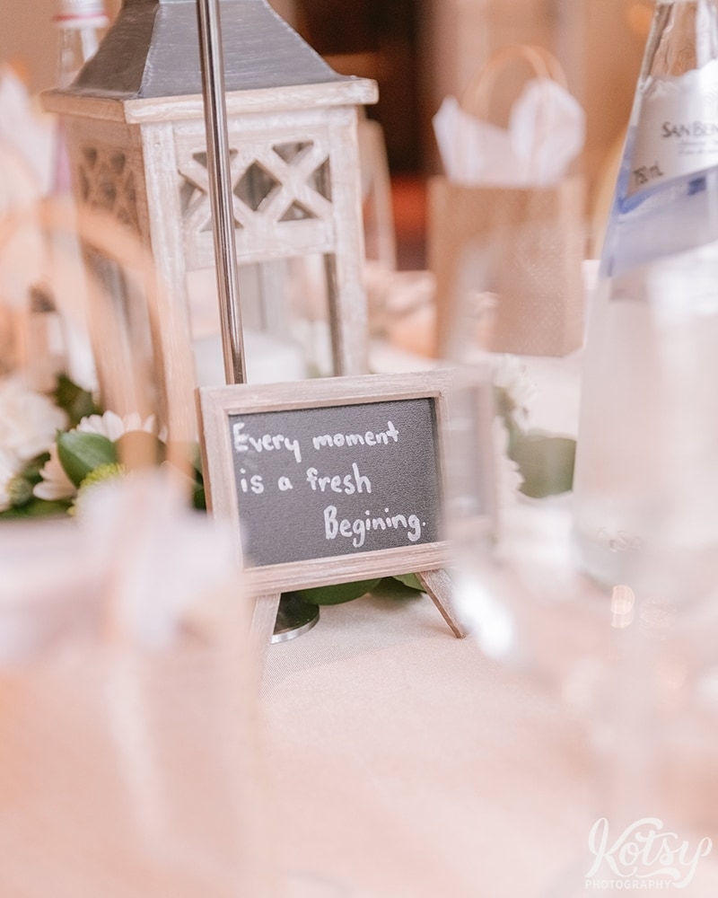 A close up shot of a little sign on a tables that reads "Every moment is a fresh beginning"