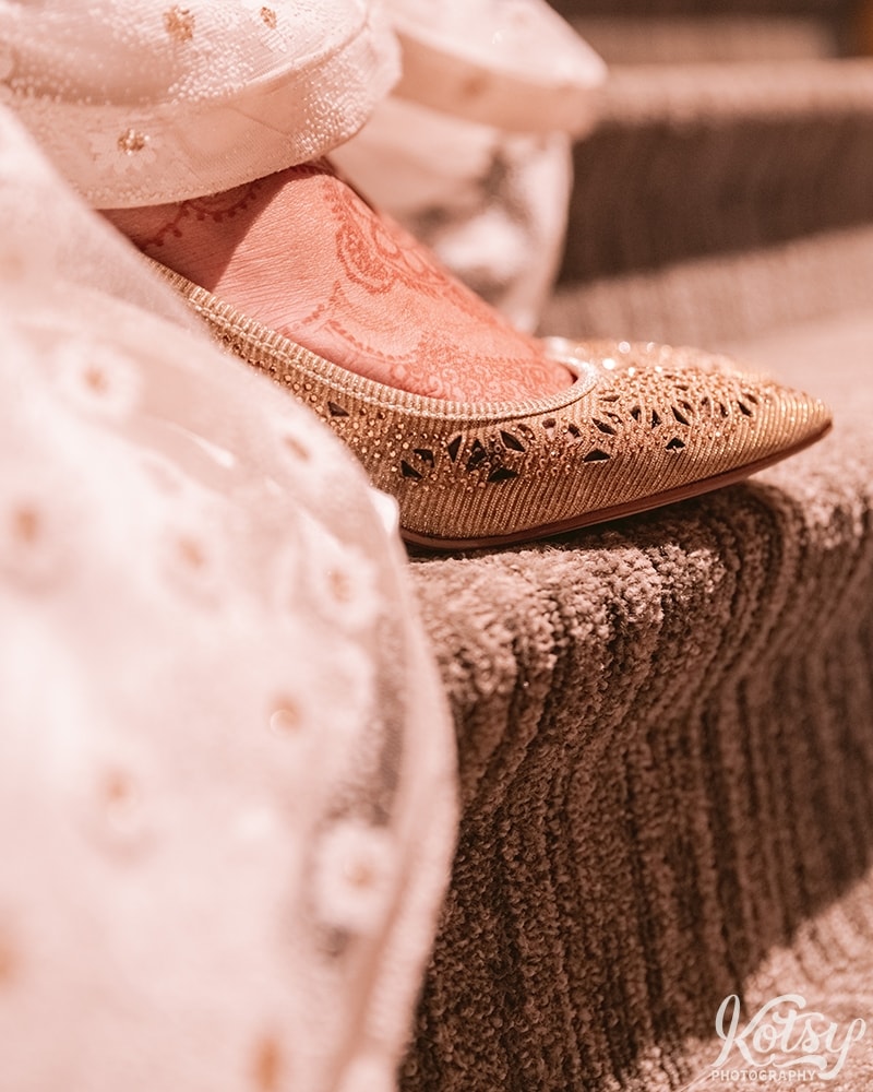A close up shot of a bride's foot slipping on a shoe at her wedding reception at Guild Inn Estate.