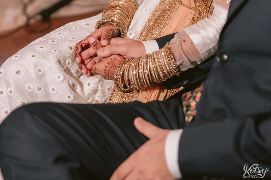 A close up shot of a bride and groom holding hands at their Guild Inn Estate wedding reception in Scarborough.