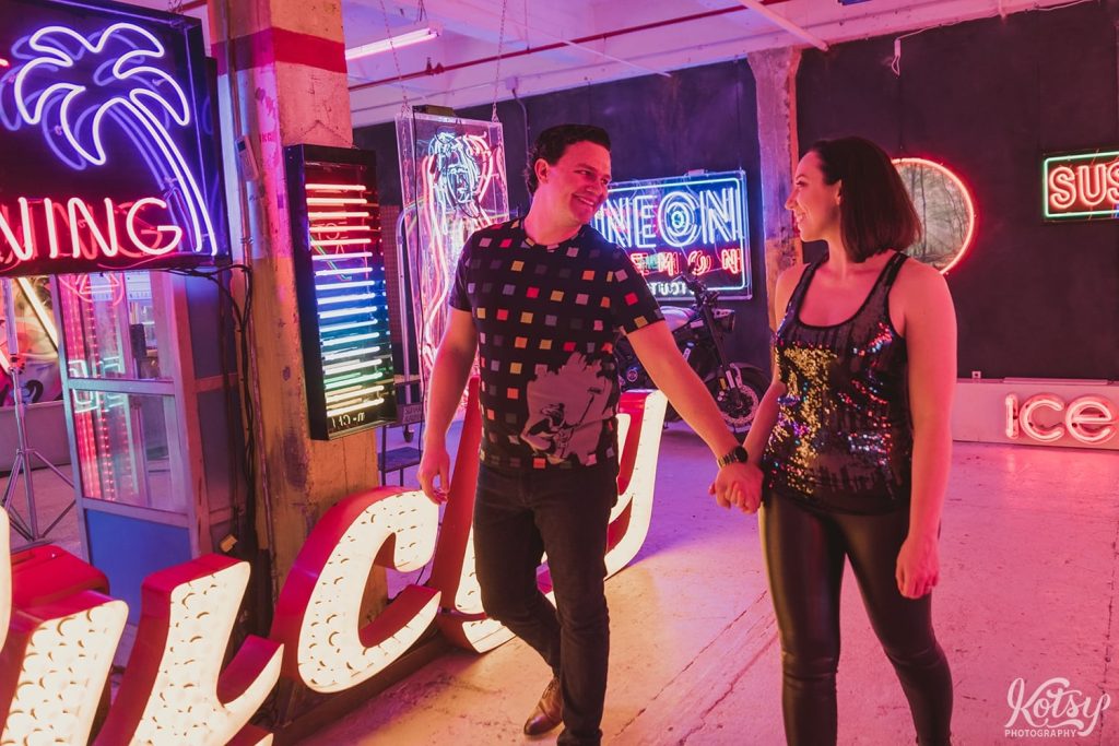 A recently engaged couple go for a walk around Neon Demon Studio in Toronto, Ontario