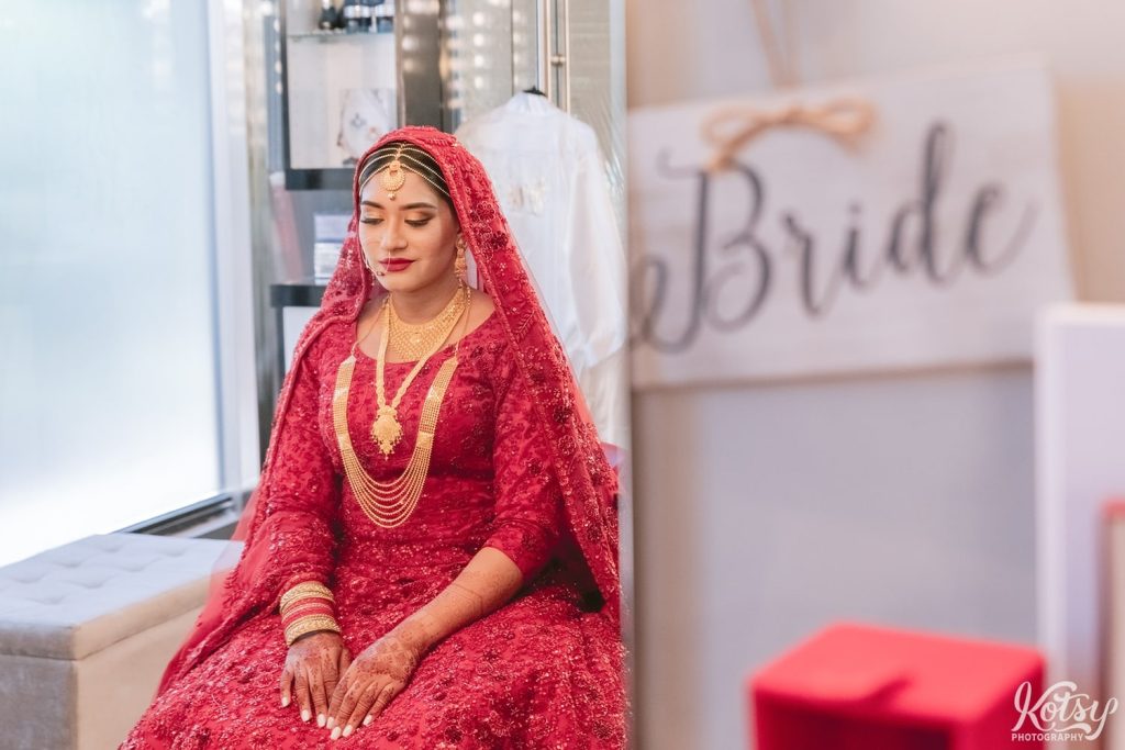 A bride is reflected in a mirror next to a 'bride' sign at The Beauty Concept in Mississauga