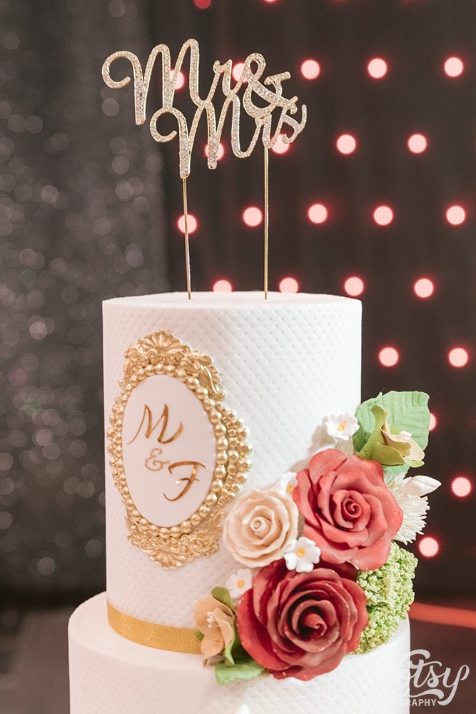 A close-up shot of a white wedding cake at a drive-thru wedding. Photograph at the Pearson Convention Centre in Mississauga, Ontario