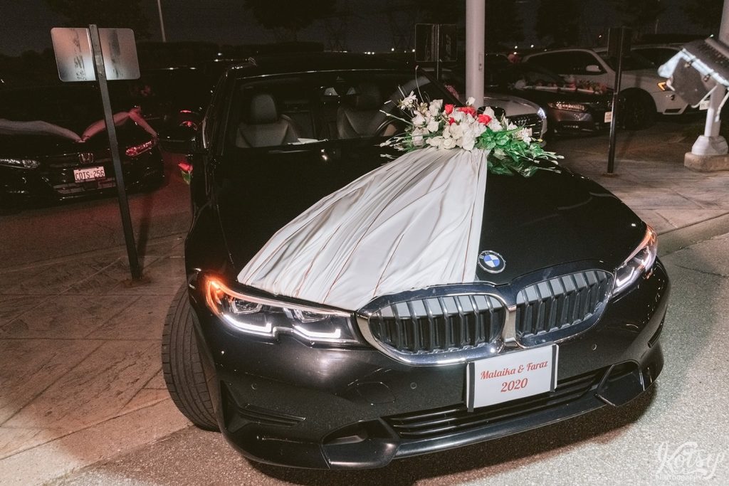 A black BMV that is gifted to a bride and groom during their drive-thru wedding at the Pearson Convention Centre in Mississauga, Ontario