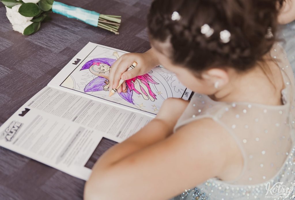 A close up shot of a girl colouring in a colouring book at a wedding reception at Universal EventSpace in Vaughan
