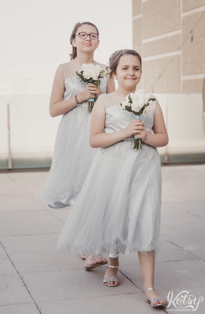 2 flower girls make their wedding down the aisle at a Univeral EventSpace wedding in Vaughan