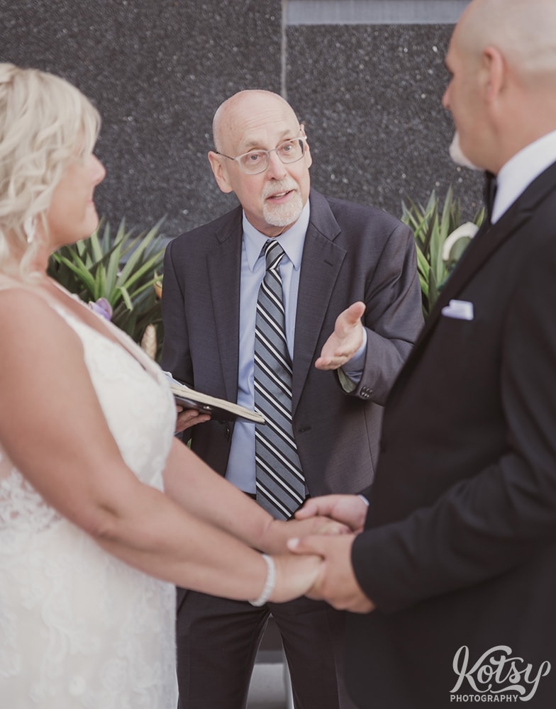 An officiant gestures with his hand while conducting a wedding ceremony at Universal EventSpace in Vaughan