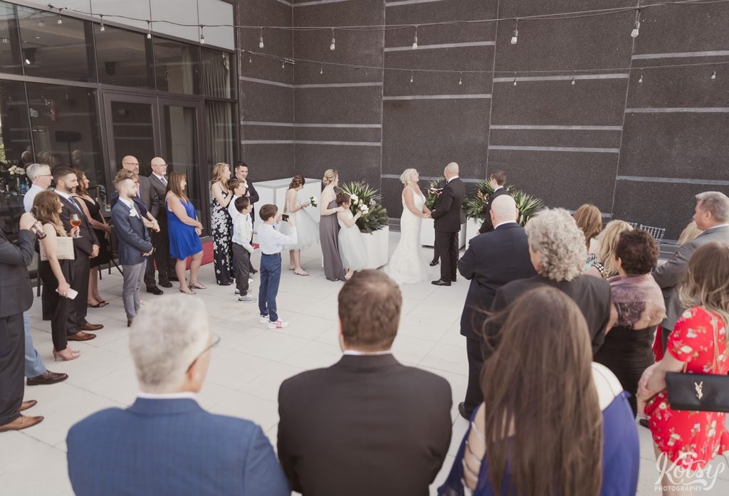 A wide shot of a wedding ceremony on an outdoor patio at Universal EventSpace in Vaughan