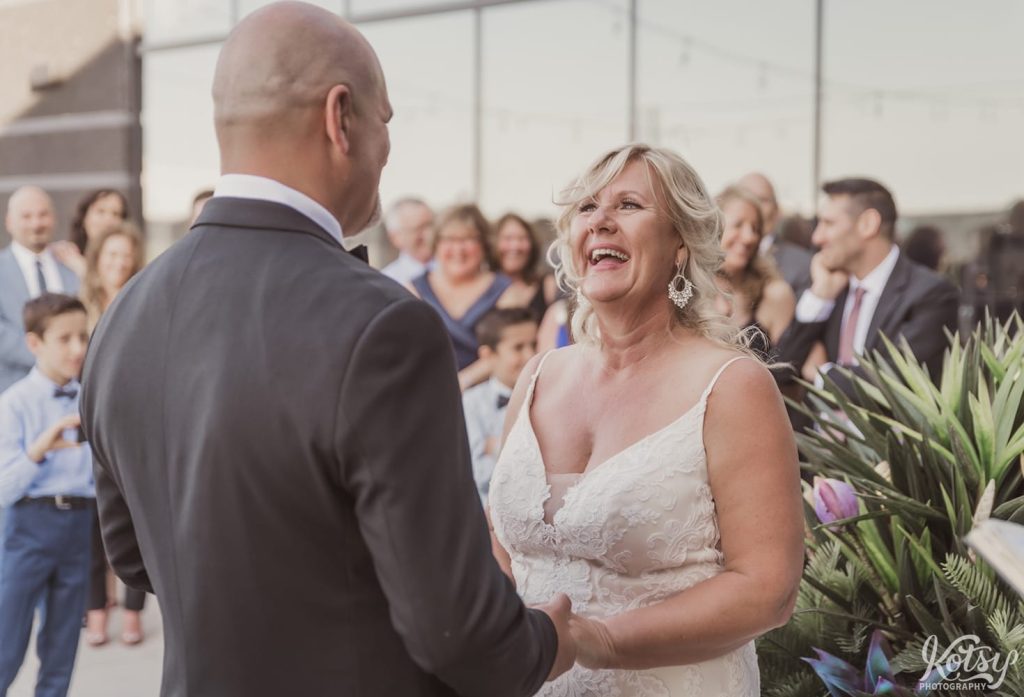 A bride lets out a huge laugh during her wedding ceremony at Universal EventSpace in Vaughan