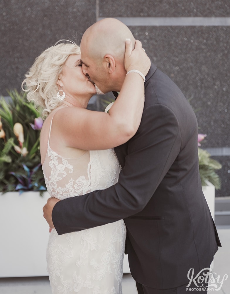 A bride and groom kiss at the conclusion of their wedding ceremony at Universal EventSpace in Vaughan