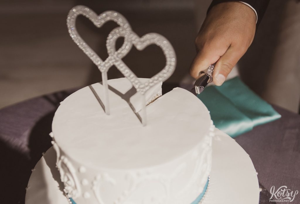A close up shot of a wedding cake being cut. Photographed at Universal EventSpace in Vaughan