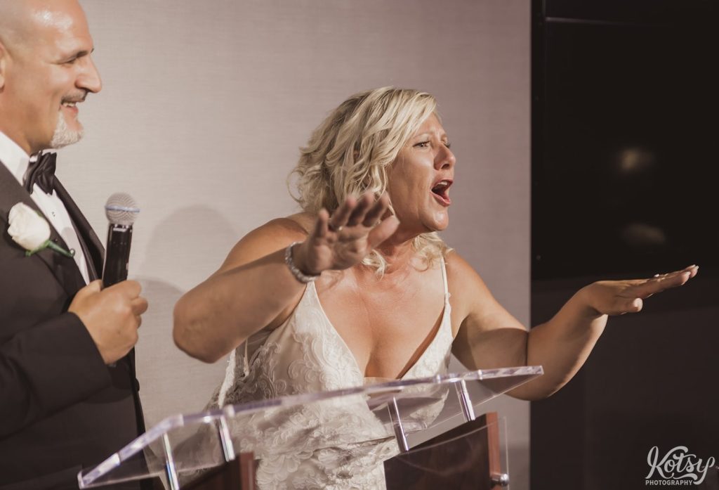 A bride gets very expressive during her groom's speech. Photographed at Universal EventSpace in Vaughan