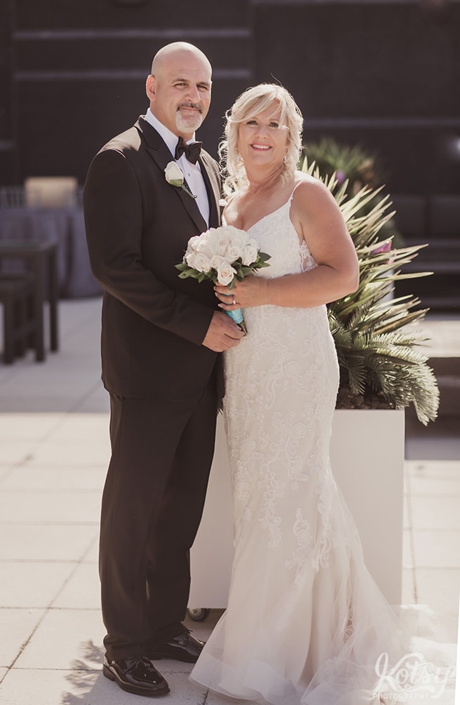 A bride and groom pose for a portrait on an outdoor patio at Universal EventSpace in Vaughan