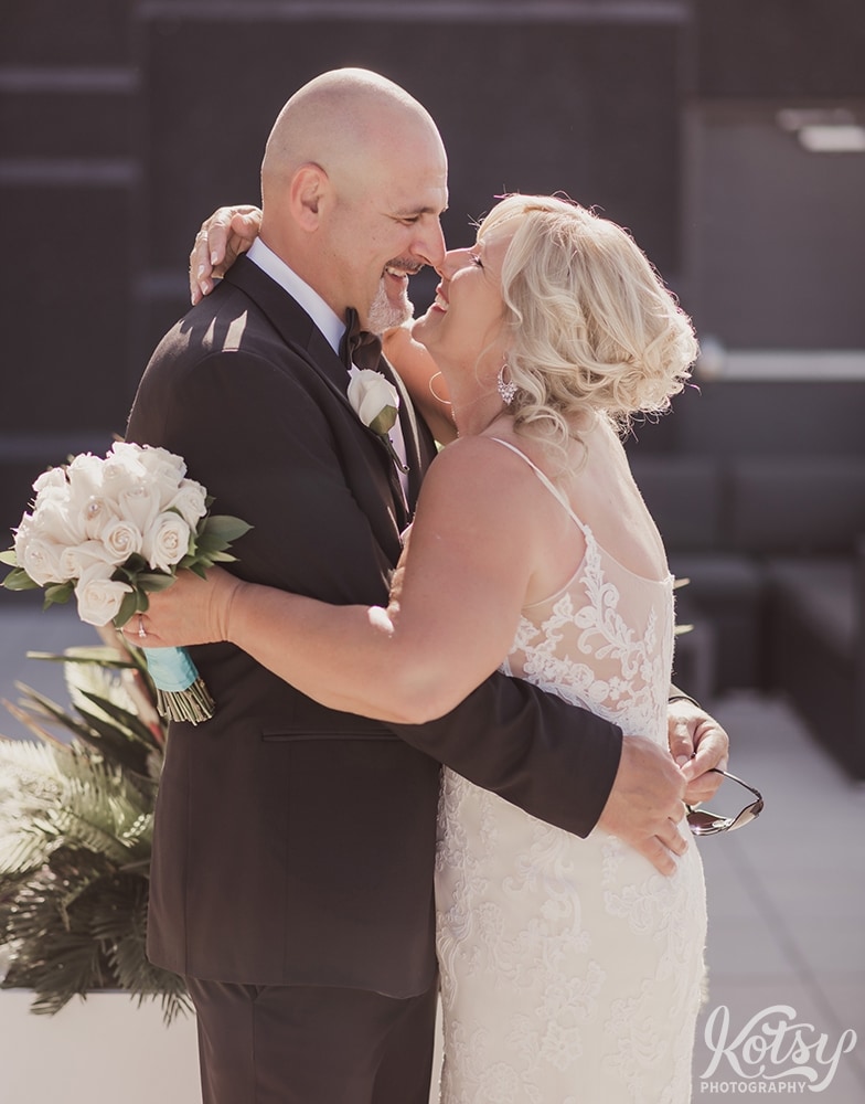 A bride and groom stand nose-to-nose with big smiles at an outdoor patio at Universal EventSpace in Vaughan