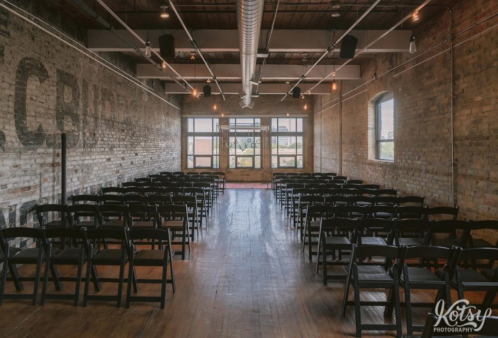 A look down the aisle at a ceremony setup of chairs at The Burroughes Building in Toronto, Ontario