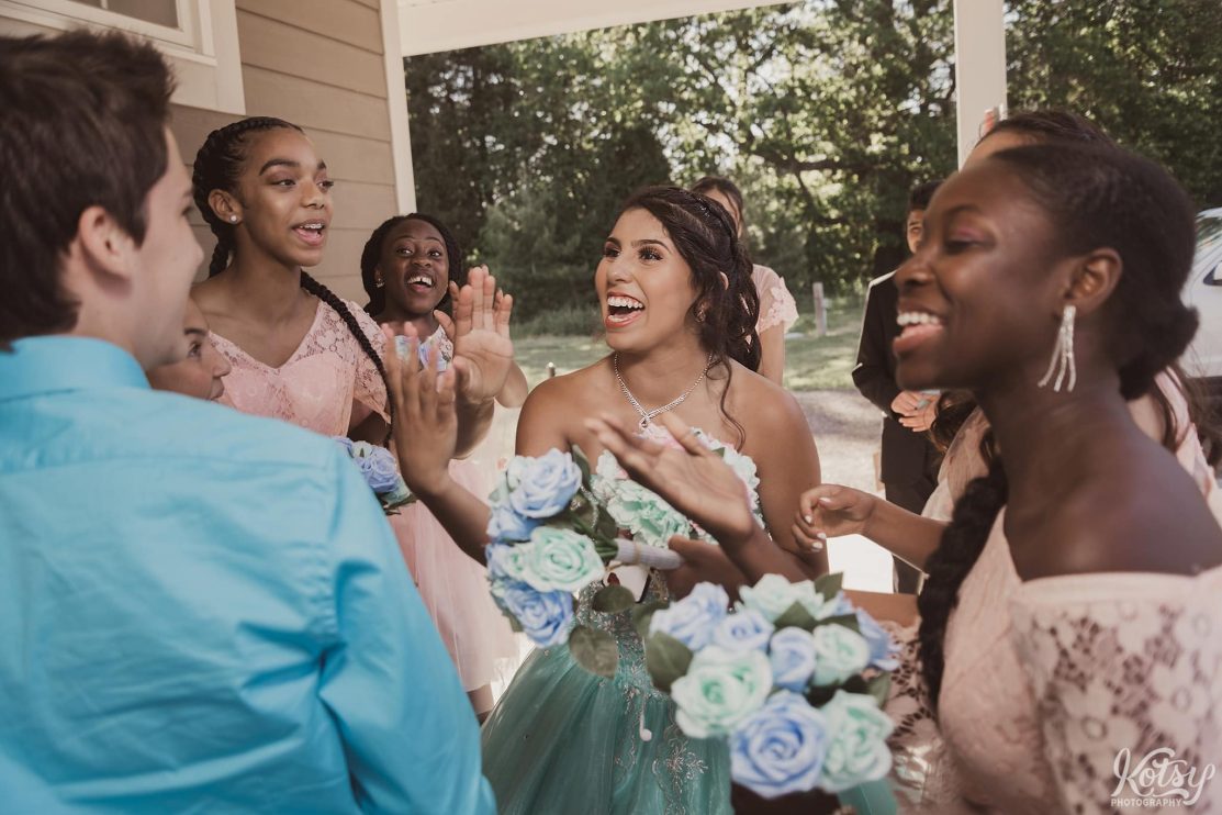 A woman enjoys a laugh with her friends at her sweet 16 party. Photographed by a Toronto Event Photographer.