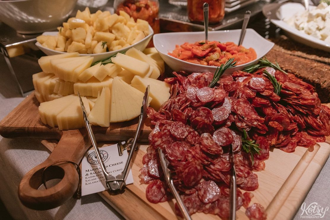 A close up shot of a food spread of pepperoni slices, cheese and more by Cookery Catering.