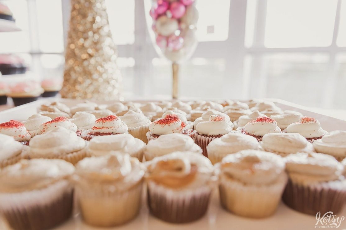 A narrow focused shot of a plate filled with cupcakes.
