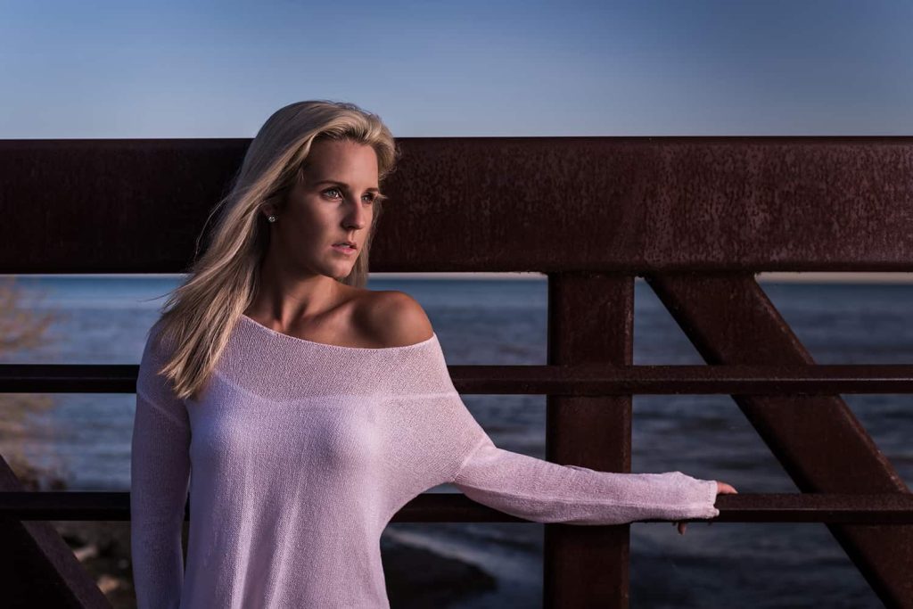 A woman poses for a portrait during blue hour in a bride in Toronto
