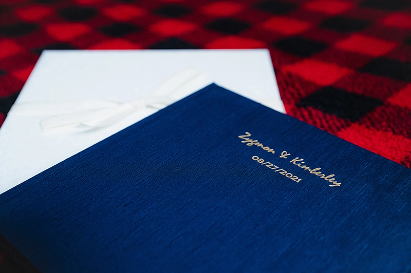 A close up of the debossing text and Asahi Navy felt cover, sitting top of a presentation box wrapped in a ribbon.