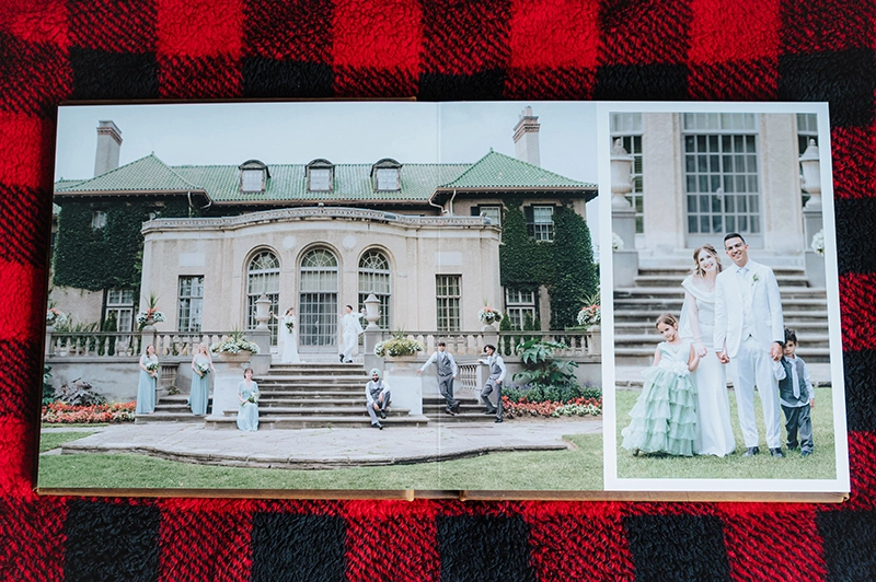 A look inside a 12x12" album feature a 3/4 spread a wedding party in front of Parkwood Estate and a bride and groom group photo with two children.