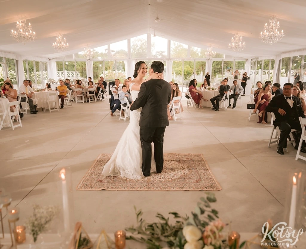 A bride and groom enjoy their first dance at Harding Waterfront Estate in Mississauga, Canada
