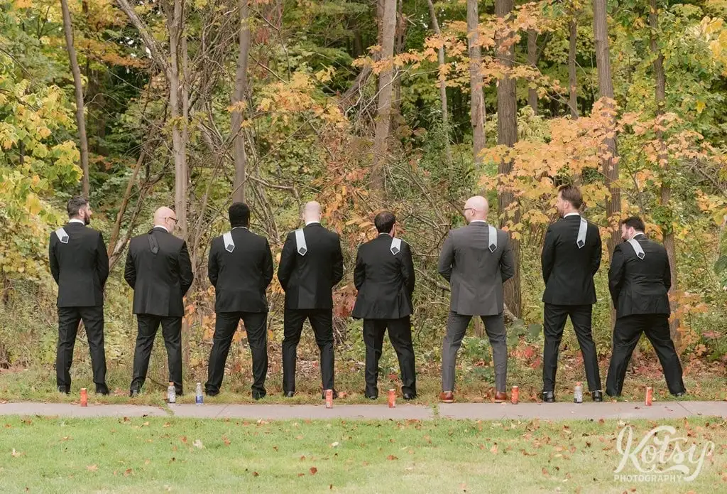 A groom and his groomsmen take a leak in unison in a forest in Toronto, Canada