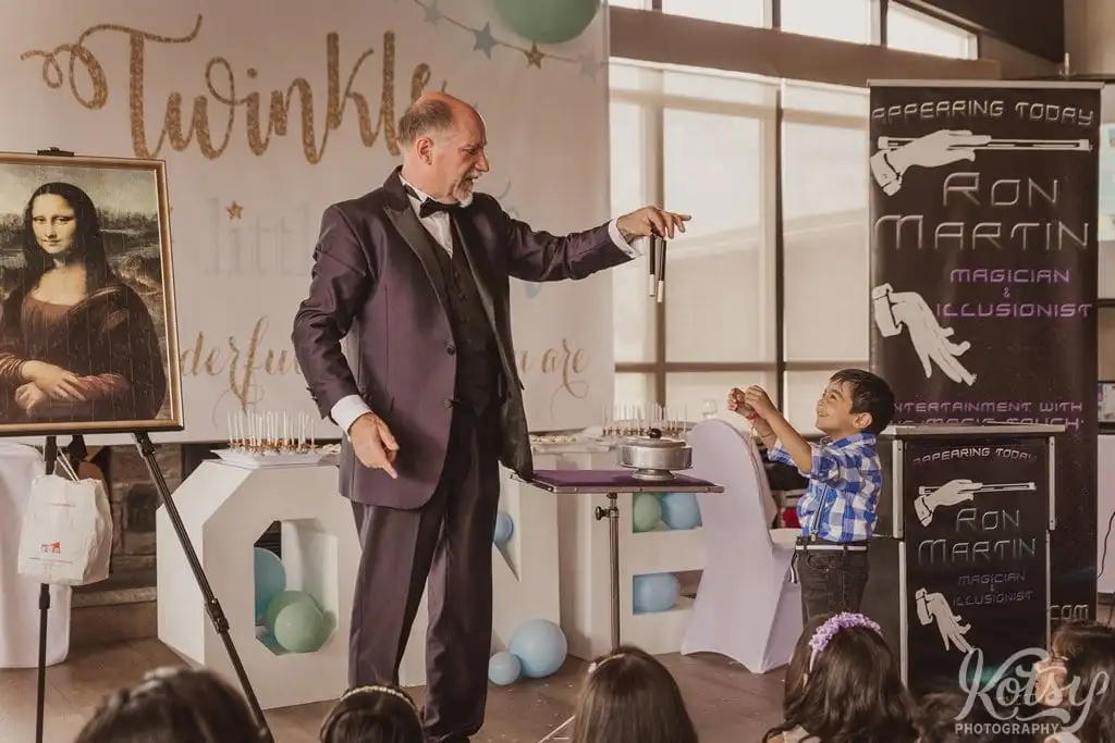 A magician performs in front of a group of children