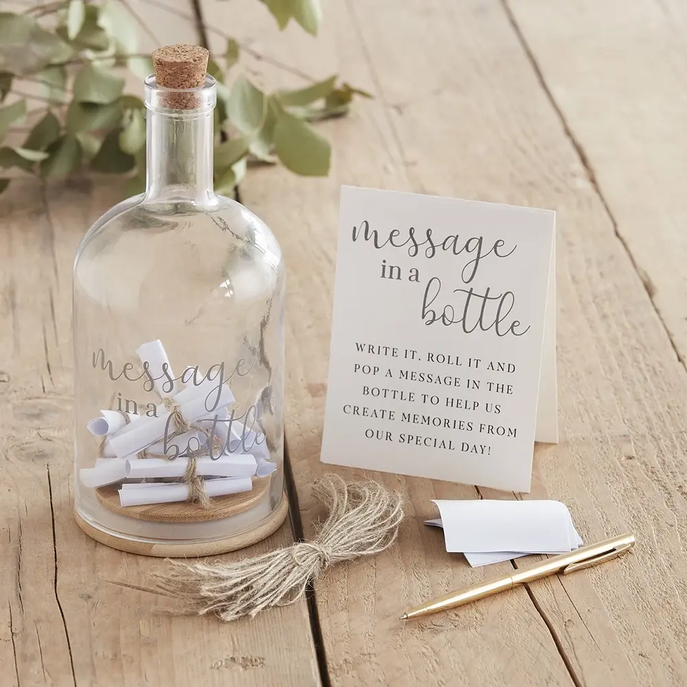 A bottle with tiny message scrolls is sign on a table at a wedding