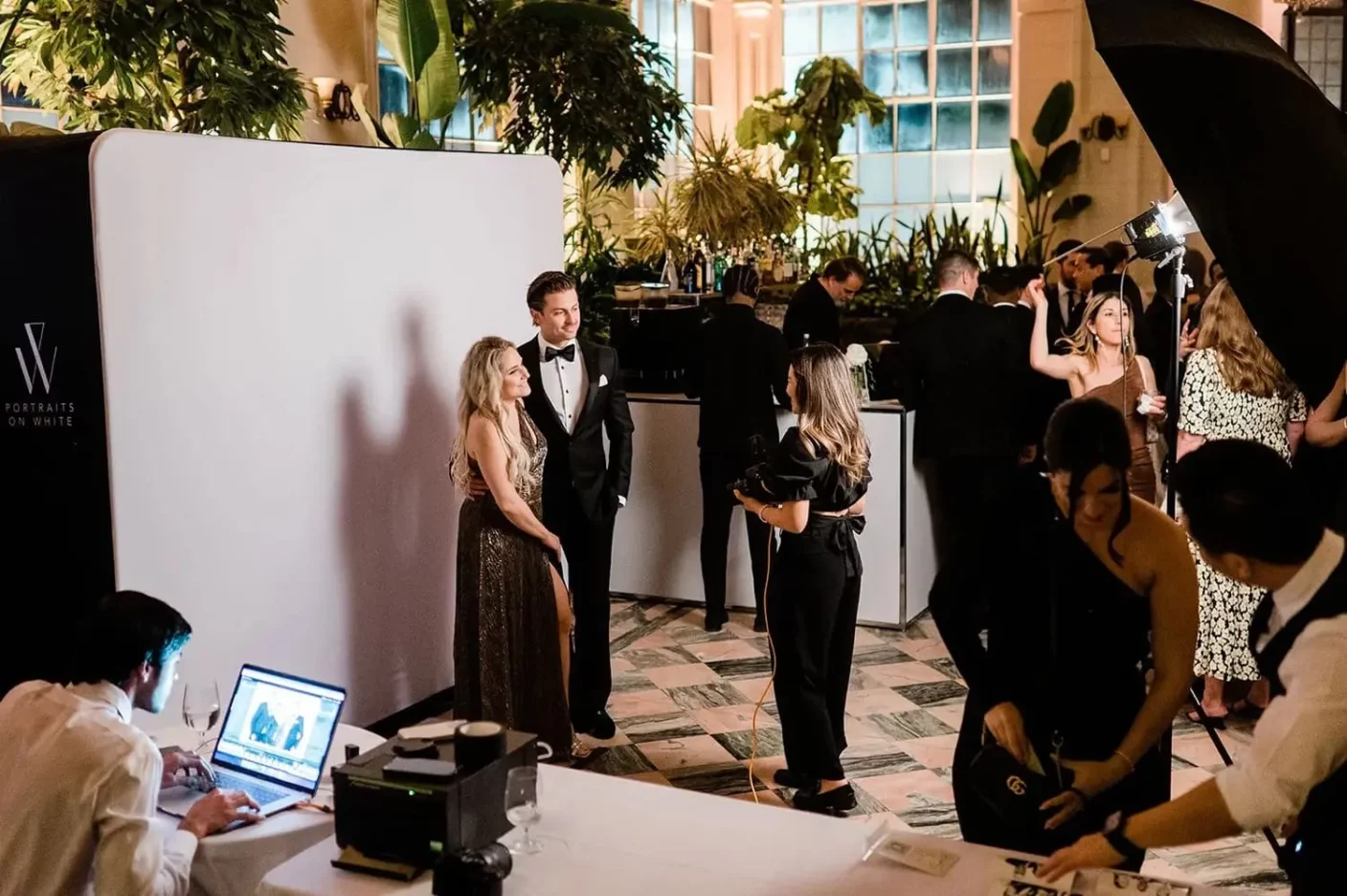 A man and a woman get ready to have their portrait taken at an upscale event in Toronto