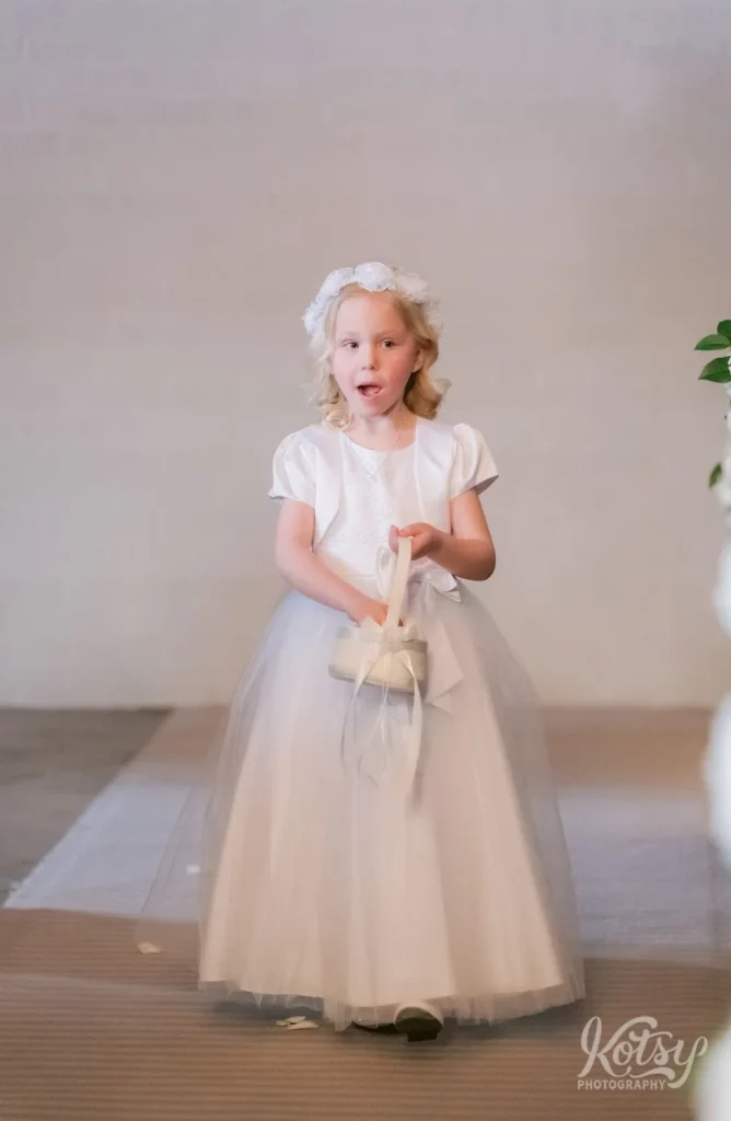The flower girl makes her way down the aisle at the Old Mill chapel in Toronto