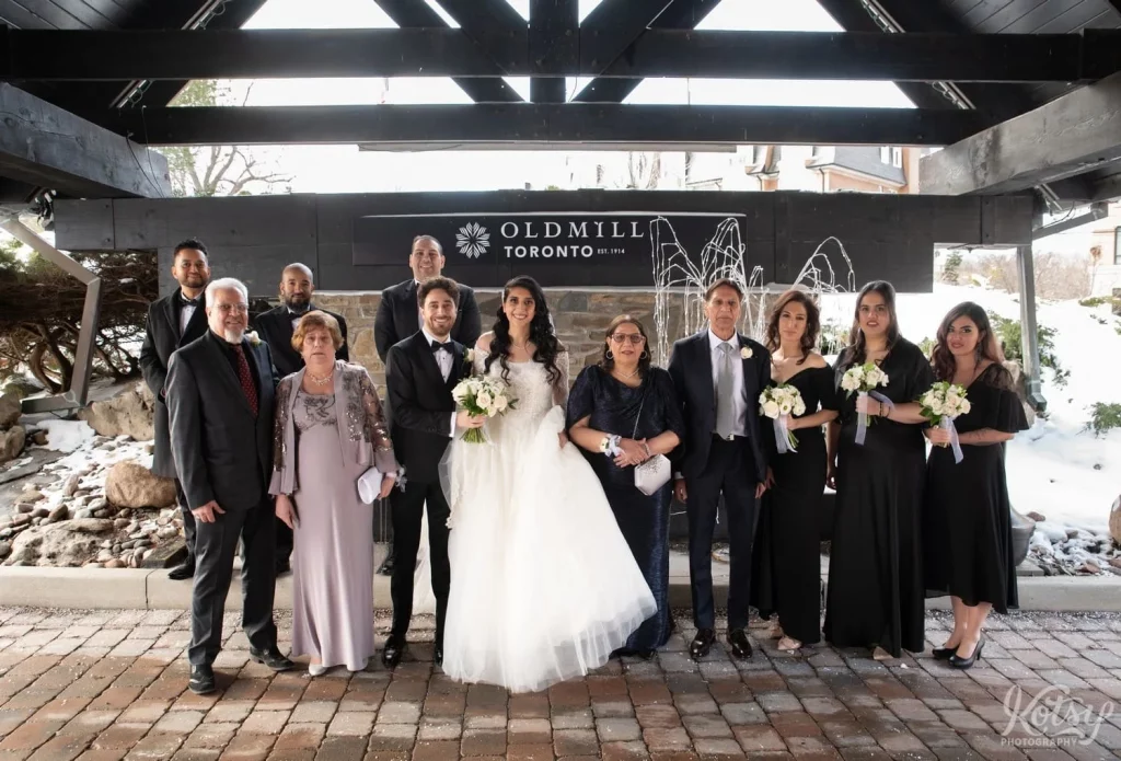 A wedding group photo with parents and wedding party at Old Mill in Toronto