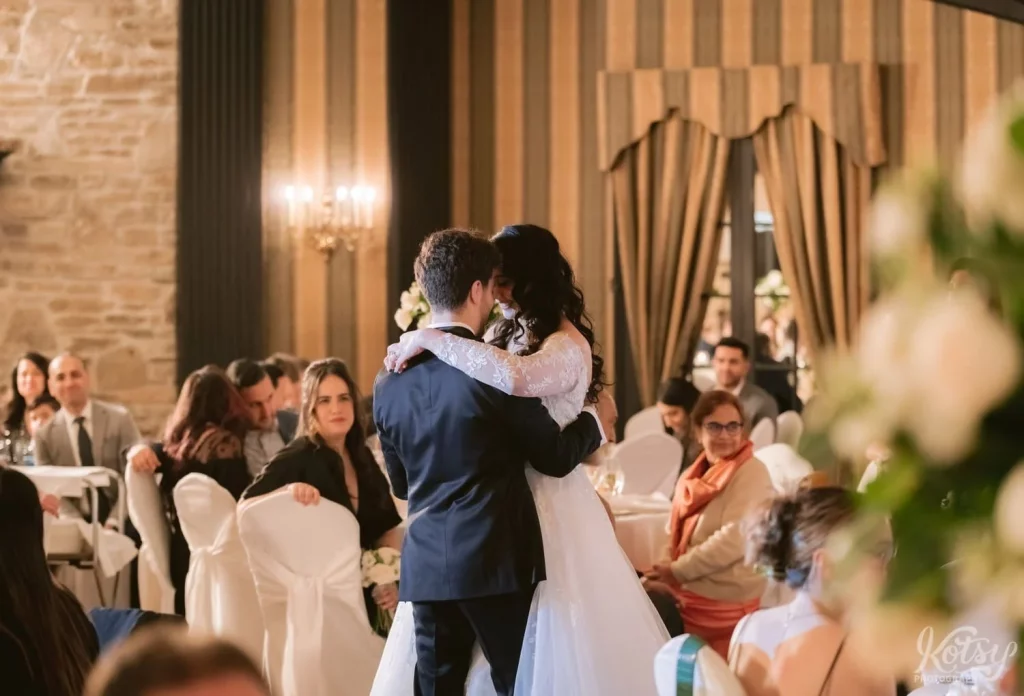 A wide shot of a bride and groom enjoying their first dance at Old Mill in Toronto