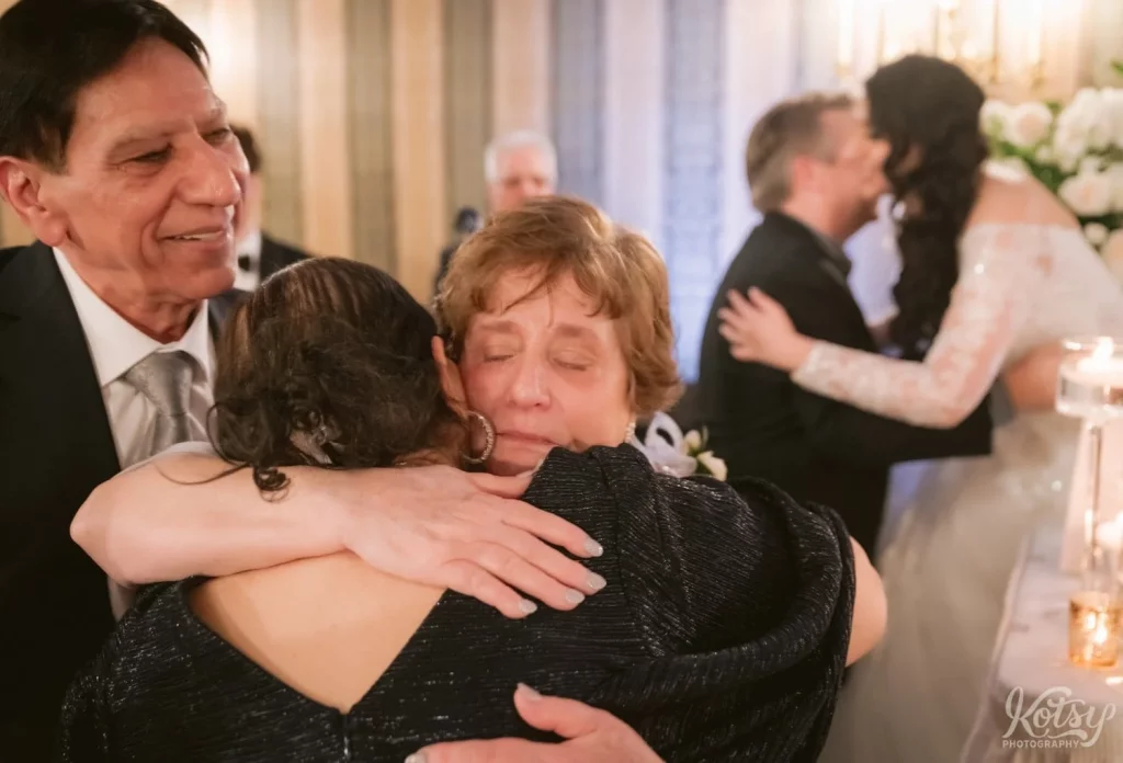The two mom's hug after a reception speech at an Old Mill wedding reception