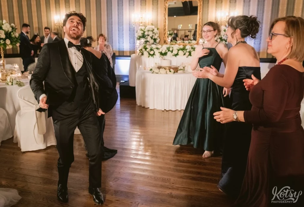A groom dances up a storm during his wedding reception at Old Mill in Toronto