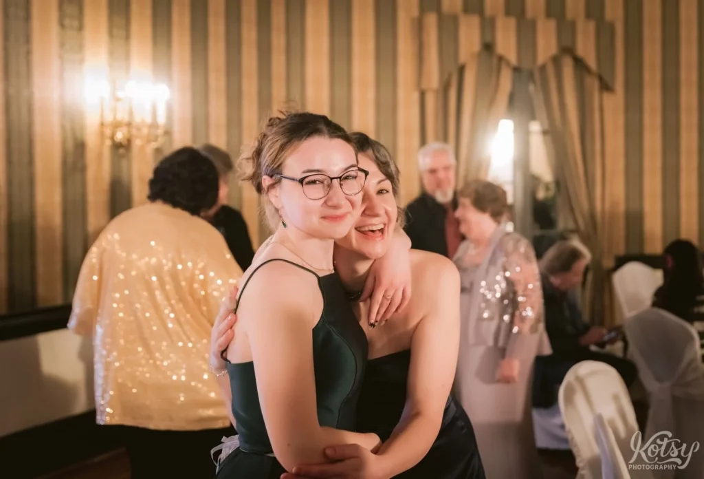 Two girls enjoy a laugh at an Old Mill wedding reception in Toronto