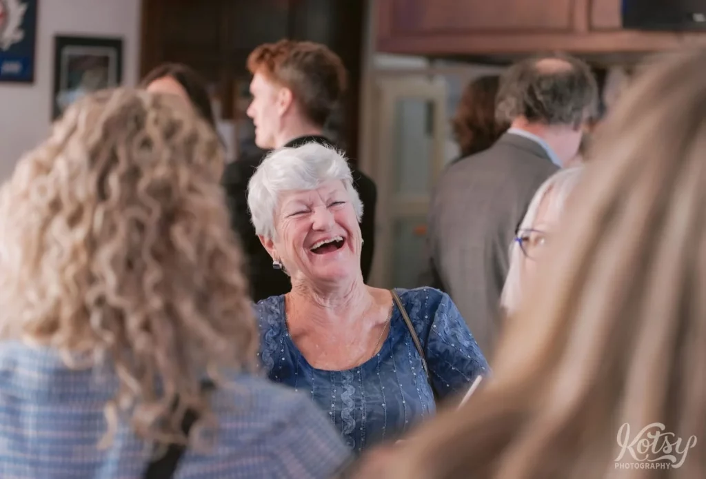 An elderly woman enjoys a laugh at a wedding in Royal Canadian Legion 344 in Toronto