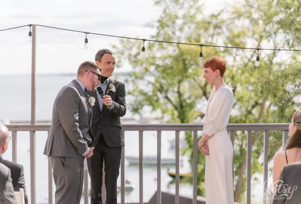A groom speaks into a mic during his lakeside wedding in Toronto