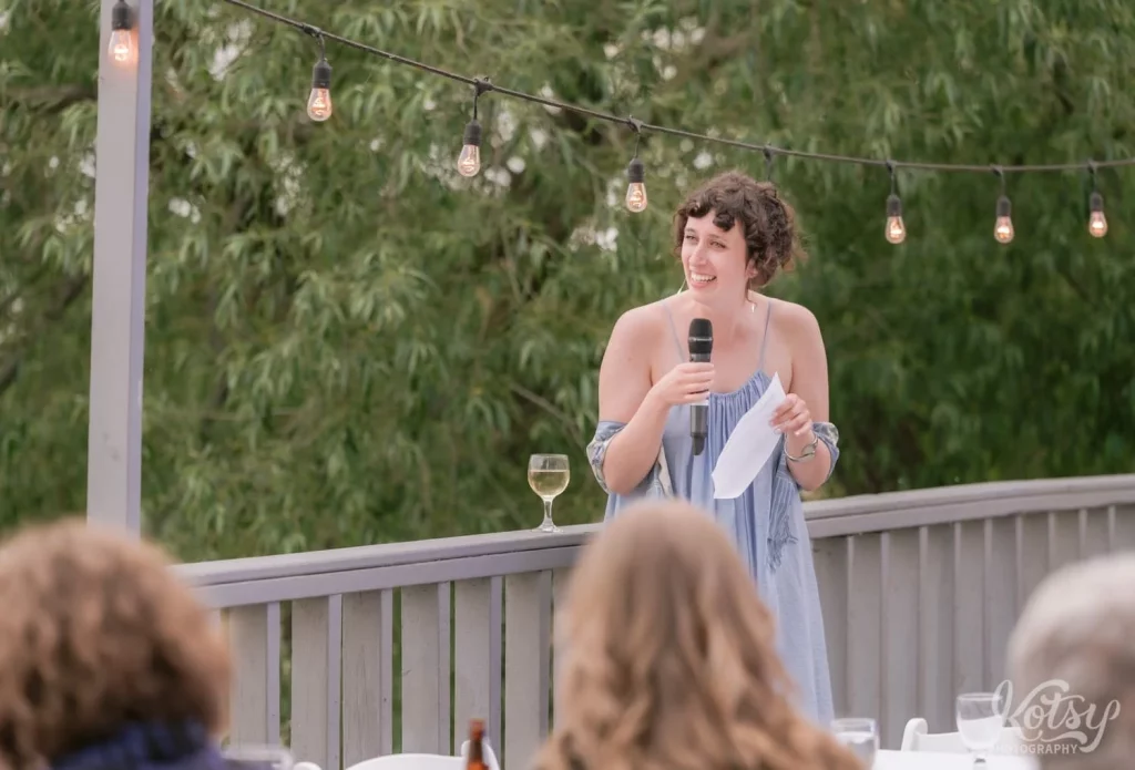 A maid of honour makes a speech at an outdoor wedding ceremony at Royal Canadian Legion in Toronto