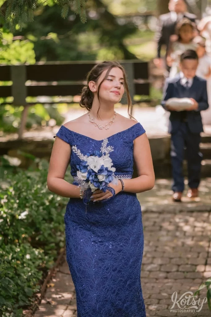 A 3rd bridesmaid makes her way down the aisle at an outdoor wedding in Toronto