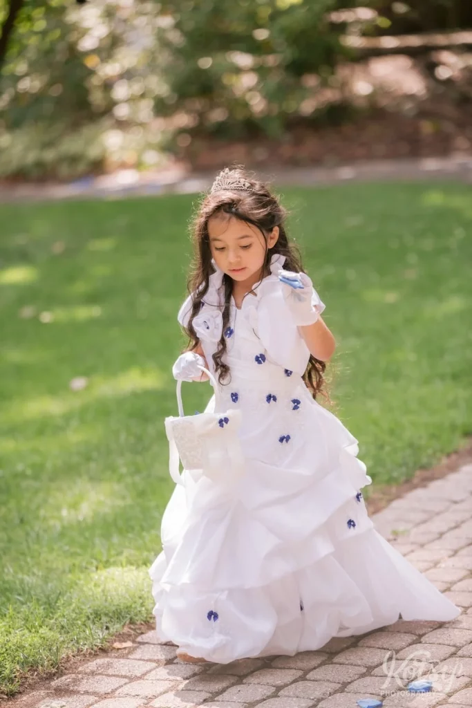 A 2nd flower girl makes her way down the aisle at an outdoor wedding in Scarborough