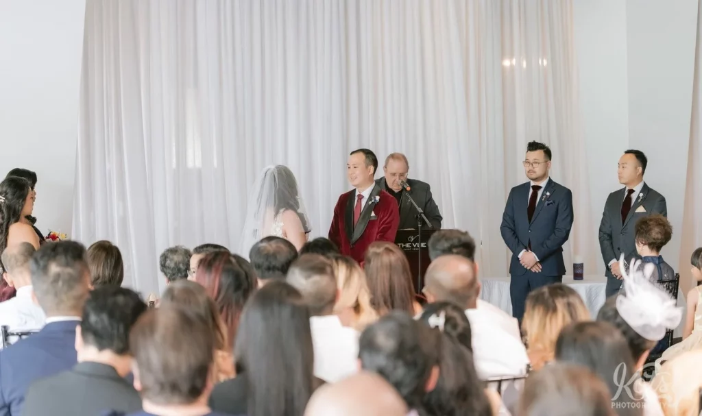 A wide shot of a bride and groom during their wedding ceremony at The Vue in Toronto