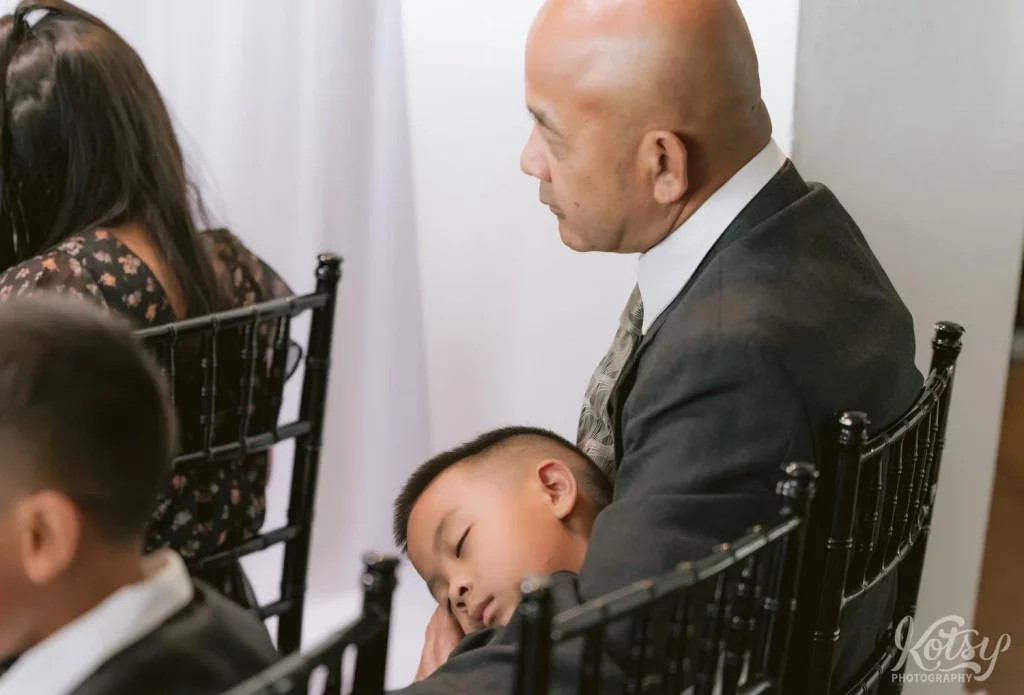 A young boy gets some shut eye during a wedding ceremony at The Vue Event Venue in Toronto