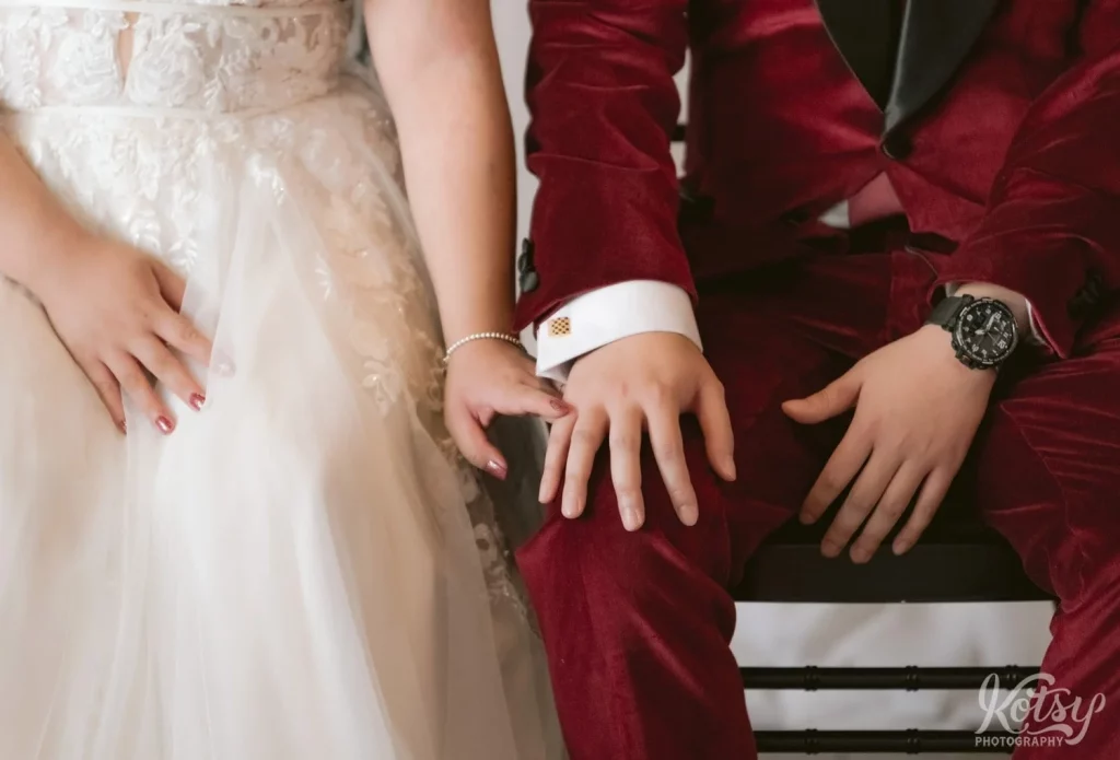 A close up shot of a bride putting her finger on her groom's hand during their wedding ceremony in Toronto