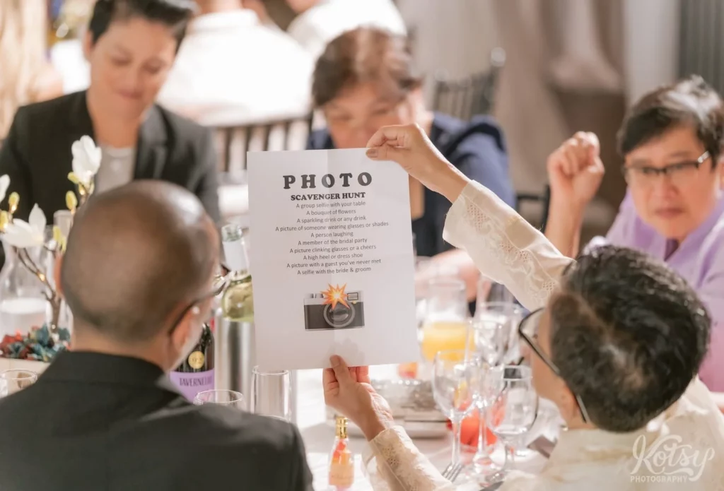 A woman reviews the instructions for a photo scavenger hunt during a wedding at The Vue Event Venue in Toronto
