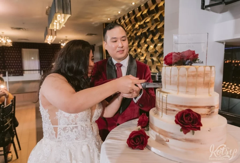 A bride and groom cut the cake at their wedding at The Vue Event Venue in Toronto